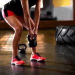 Female crossfit athlete exercise at crossfit gym